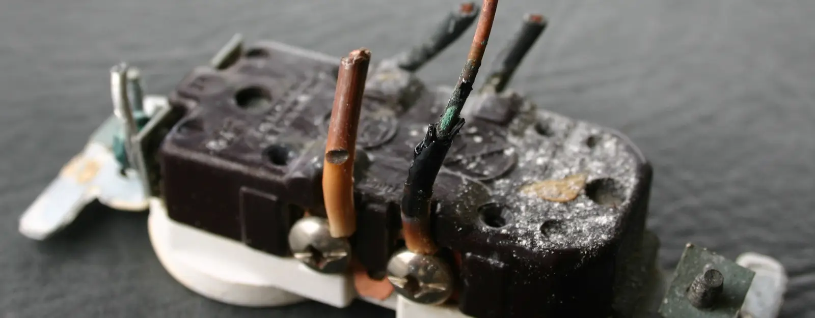Close-up of aluminum wiring connection being inspected