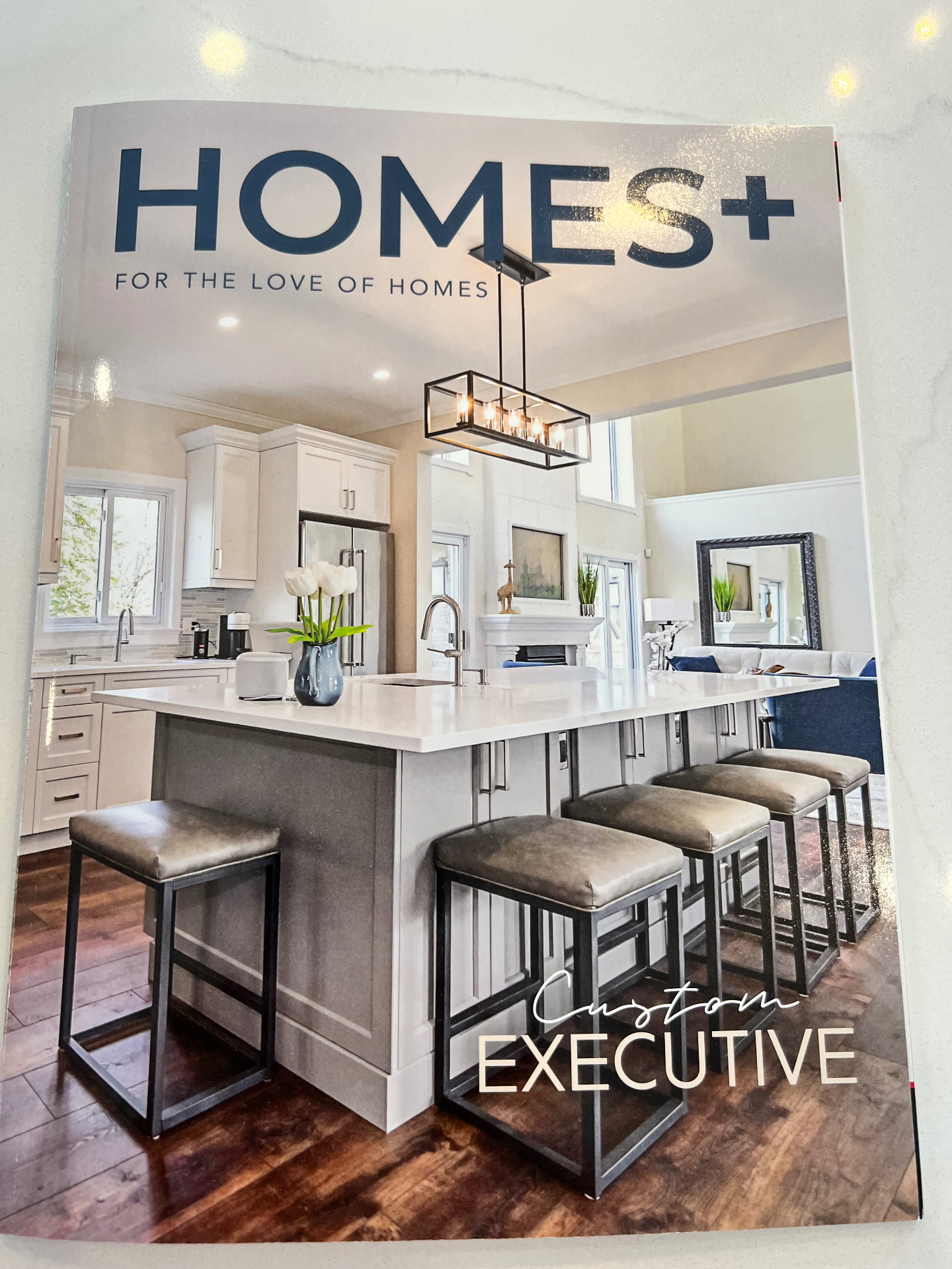 HOMES+ Magazine cover featuring a custom executive home renovation by Inline Electric