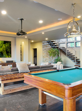 Finished basement recreation room with pot lights, pendant fixture, and pool table — electrical by Inline Electric